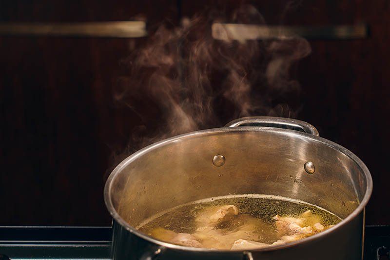 pieces-of-white-chicken-meat-are-boiled-in-a-saucepan_Alex-Boc_Shutterstock
