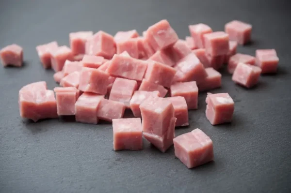 ham pieces cut up on a wooden cutting board pork meat